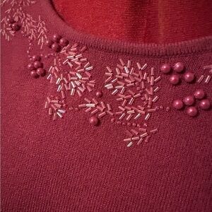 Tradition petite long sleeve sweater with beading along the front neckline.